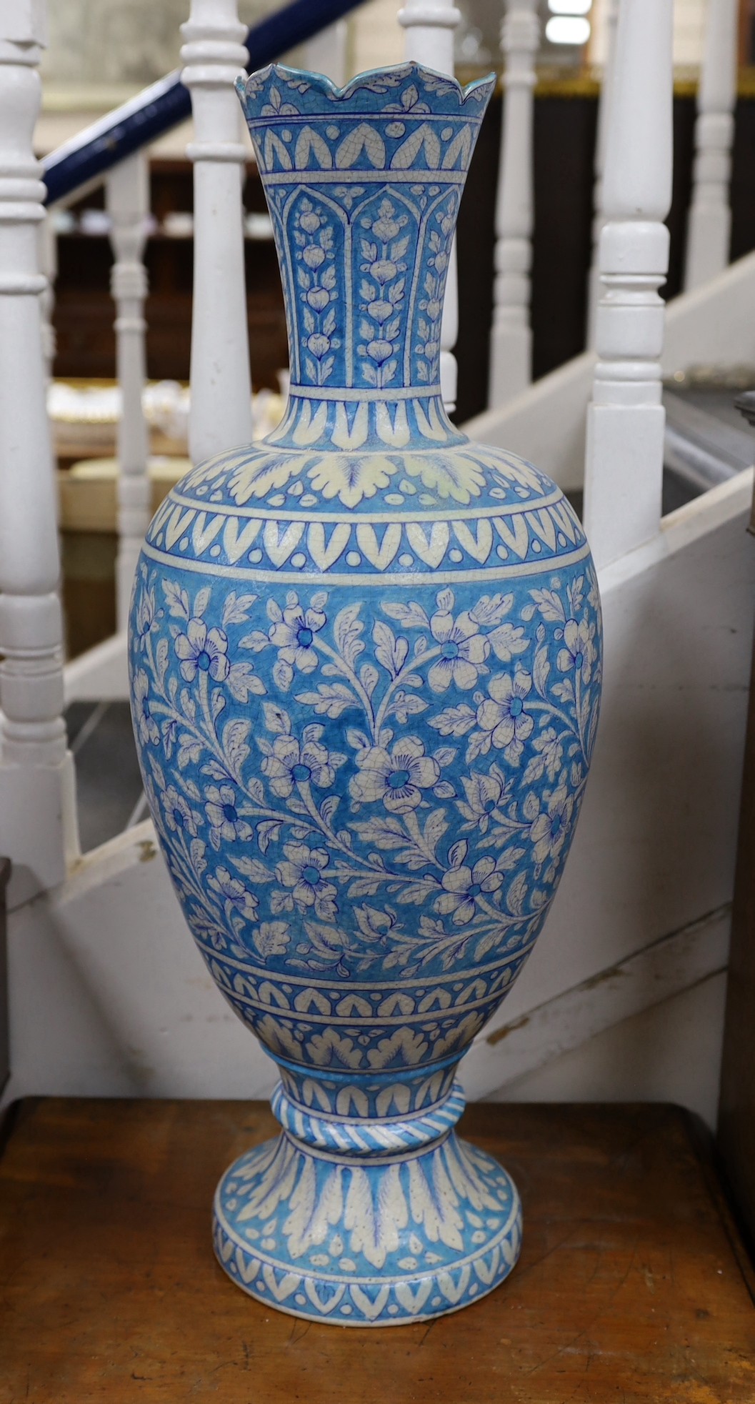 A large Persian fritware floral decorated vase, 67cm tall